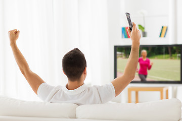 Image showing man watching sport channel on tv and at home