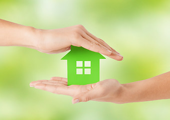 Image showing close up of woman hands holding green house