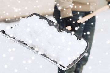 Image showing closeup of man digging snow with shovel