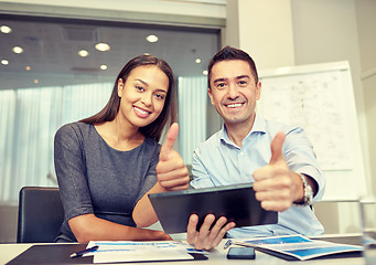 Image showing smiling businesspeople with tablet pc in office