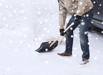 Image showing closeup of man digging snow with shovel near car