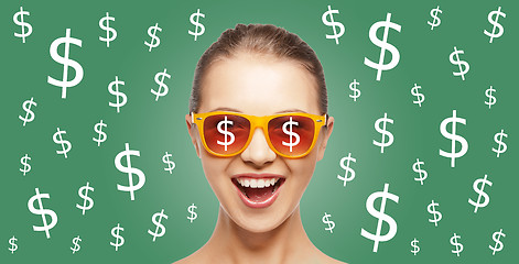 Image showing happy woman in shades with dollar currency sings