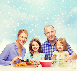 Image showing happy family with two kids making dinner at home