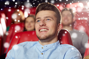 Image showing happy young man watching movie in theater