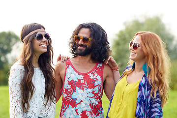 Image showing smiling young hippie friends talking outdoors