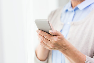 Image showing close up of senior woman with smartphone texting