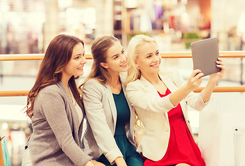 Image showing happy young women with tablet pc and shopping bags