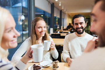 Image showing happy friends meeting and drinking tea or coffee