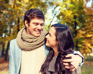 Image showing smiling couple hugging in autumn park