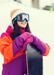 Image showing happy young woman with snowboard outdoors