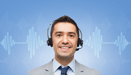 Image showing businessman in headset over sound wave or diagram