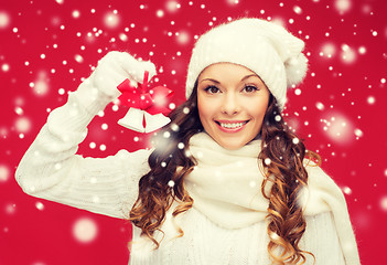 Image showing smiling woman in mittens and hat with jingle bells