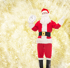 Image showing man in costume of santa claus with clock