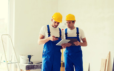 Image showing builders with tablet pc and equipment indoors