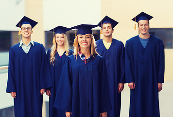 Image showing group of smiling students in mortarboards