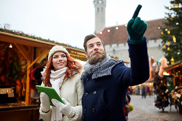 Image showing happy couple walking with tablet pc in old town