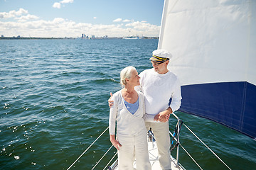 Image showing senior couple hugging on sail boat or yacht in sea