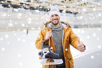 Image showing happy young man showing thumbs up on skating rink