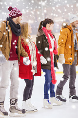 Image showing happy friends on skating rink