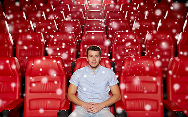 Image showing happy young man watching movie in theater