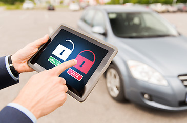 Image showing close up of hands with lock icons on tablet pc