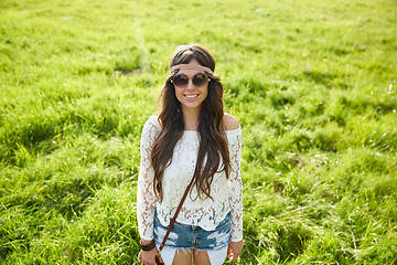 Image showing smiling young hippie woman on green field