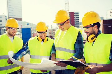 Image showing group of builders with tablet pc and blueprint