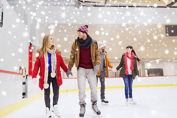 Image showing happy friends on skating rink