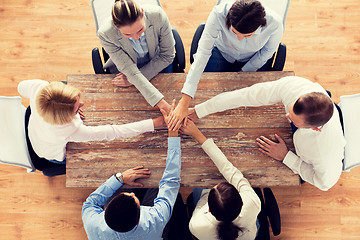 Image showing close up of business team with hands on top