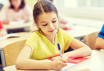 Image showing group of school kids writing test in classroom