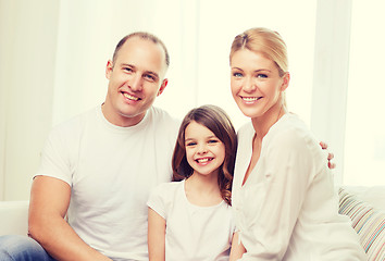 Image showing smiling parents and little girl at home