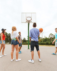 Image showing group of happy teenagers playing basketball