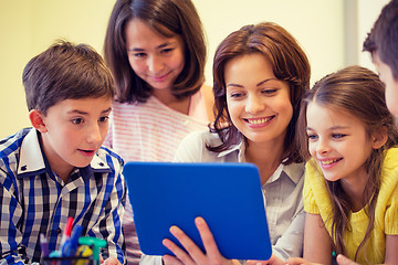 Image showing group of kids with teacher and tablet pc at school