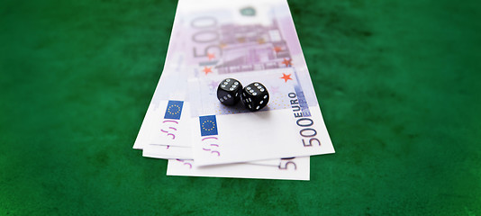 Image showing close up of black dice and euro cash money