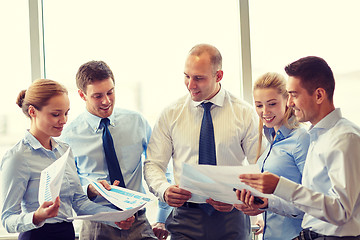 Image showing happy business people with papers talkig in office