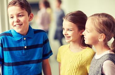 Image showing group of smiling school kids talking in corridor