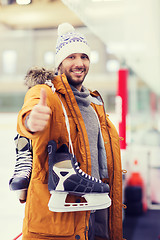 Image showing happy young man showing thumbs up on skating rink