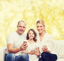 Image showing happy family with smartphones