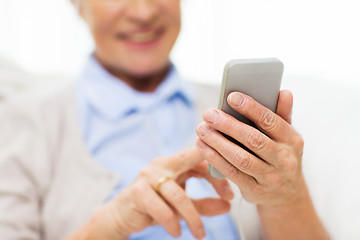 Image showing close up of senior woman with smartphone texting