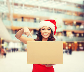 Image showing smiling woman in santa helper hat with parcel box