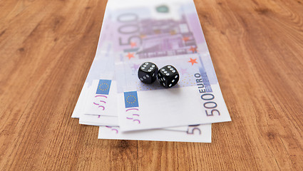 Image showing close up of black dice and euro cash money