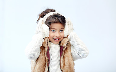 Image showing happy little girl wearing earmuffs