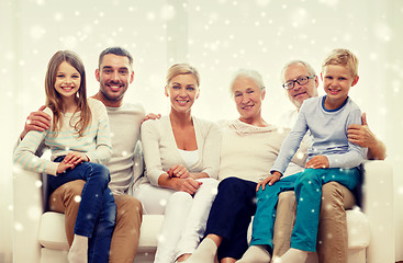 Image showing happy family sitting on couch at home