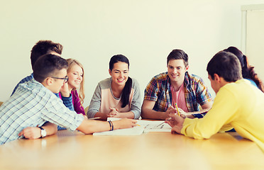 Image showing group of smiling students with blueprint