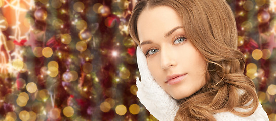 Image showing woman in gloves over christmas lights background