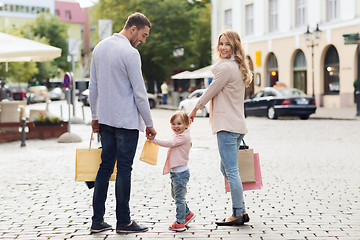 Image showing happy family with child and shopping bags in city