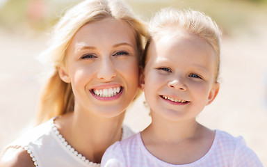 Image showing happy mother and little daughter on summer beach