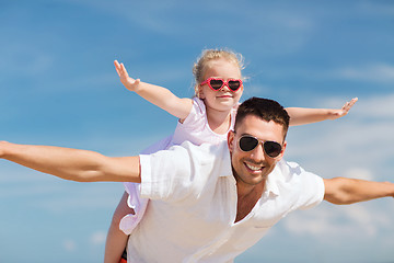 Image showing happy family having fun over blue sky background