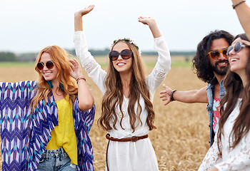 Image showing happy young hippie friends dancing on cereal field