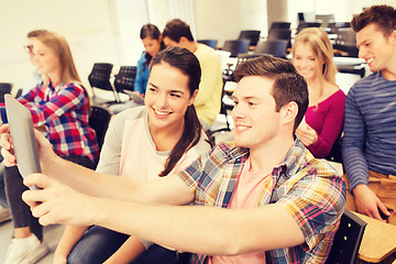 Image showing group of smiling students with tablet pc